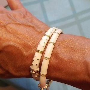Two Enamel white and gold bangles